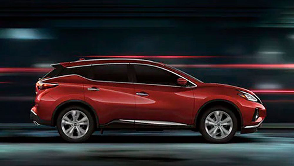 2023 Nissan Murano shown in profile driving down a street at night illustrating performance. | All Star Nissan in Denham Springs LA
